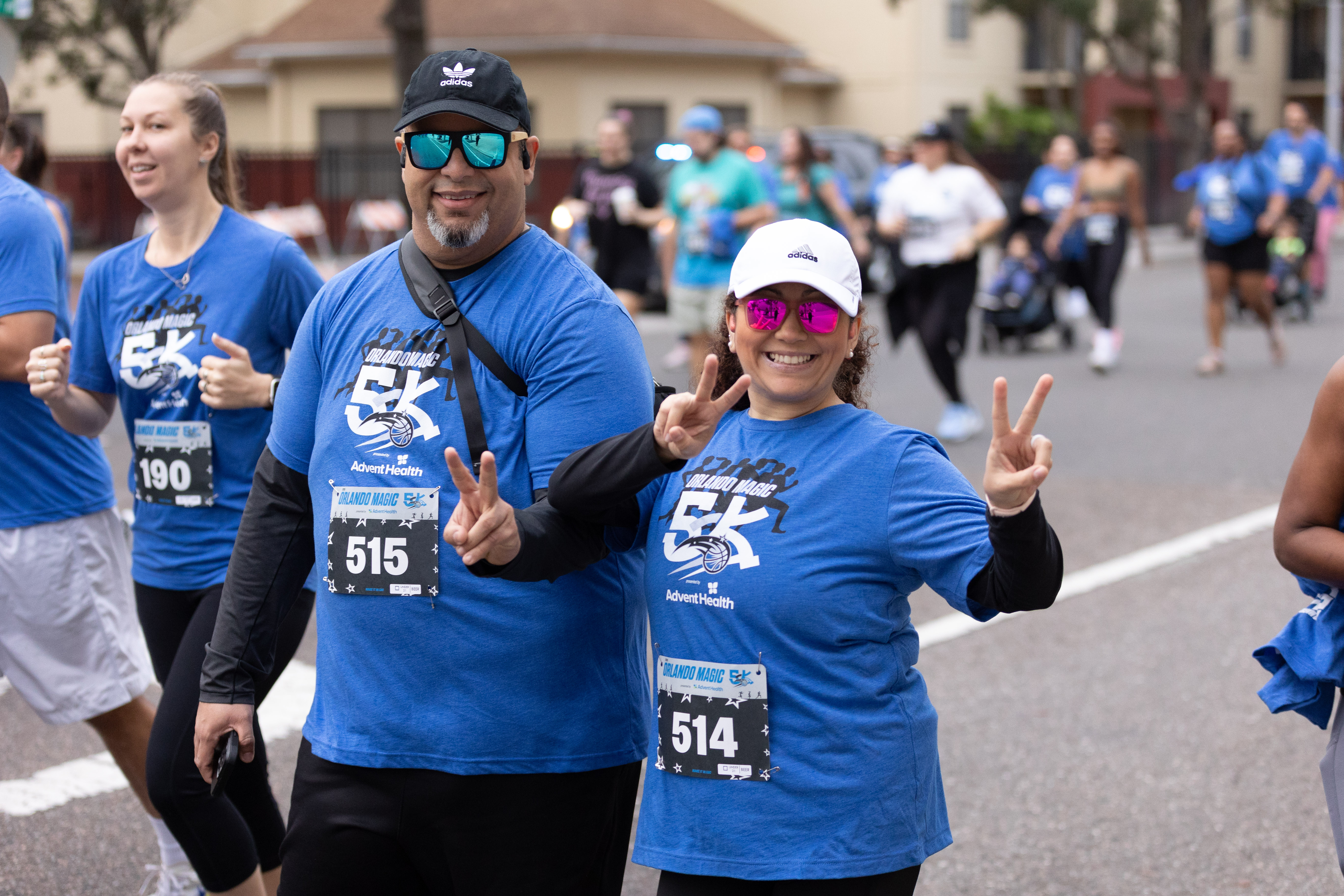 Man and woman walking with two thumbs up  