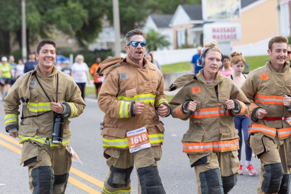 Firefighters in uniform running the Corporate 5K