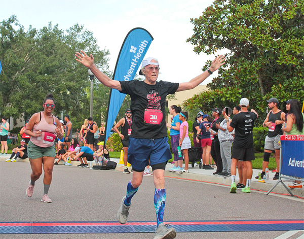 Man crossing finish line at Battle of the Bands